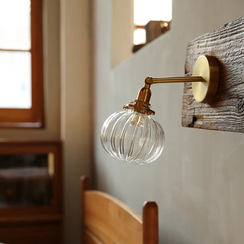 Glass wall lamp with a transparent or blue shade for living room or bedroom.
