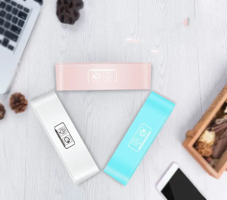 Rectangular blue LED atmosphere alarm clock with digital display on a wooden surface.