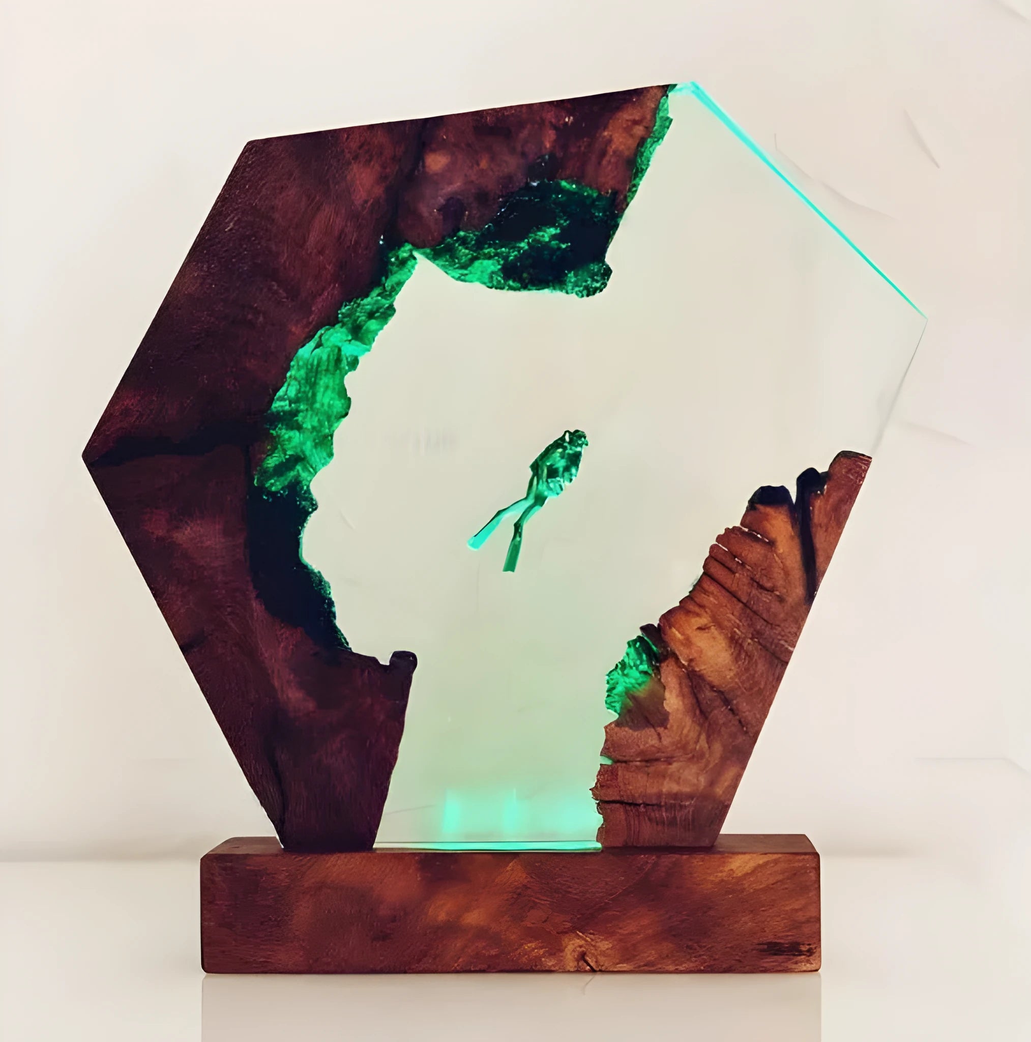 Resin luminous diver and humpback whale night light with USB cable on a shelf