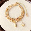 Women's three-circle citrine bracelet with caramel crystals and gold electroplated finish showing Saturn design detail
