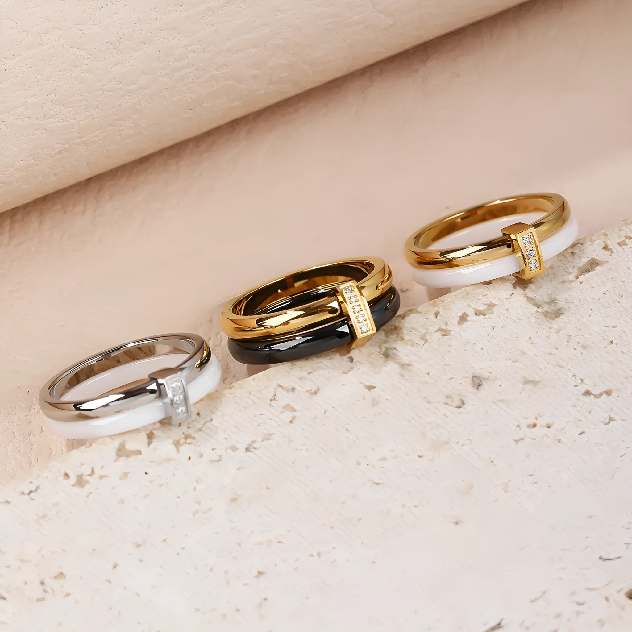 Women's heart-shaped titanium steel ring with glossy stitching and zirconium detail in gold black, golden white, and steel white.