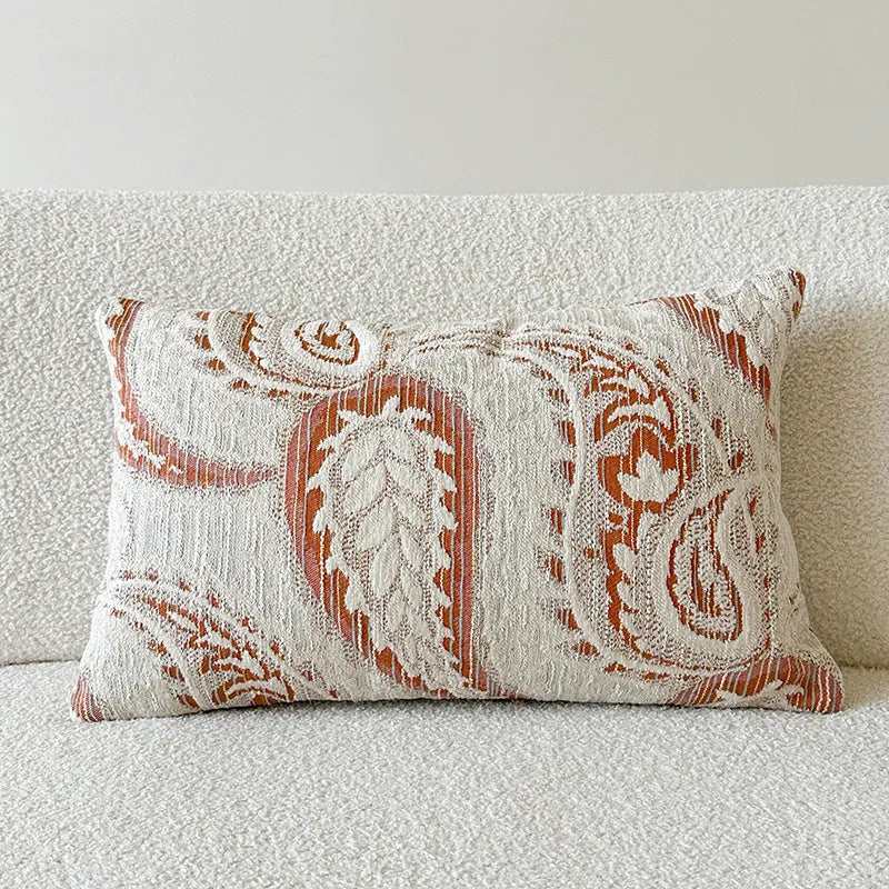 American-style jacquard woven throw pillow cover with a paisley pattern in amber colours on a sofa.