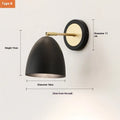 Nordic style iron wall lamp mounted on a wall, showcasing its welded shade design.