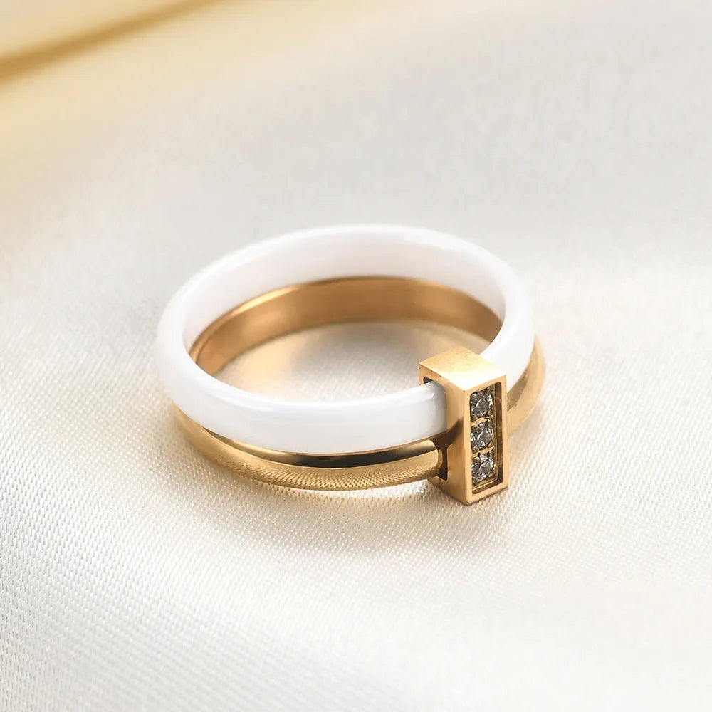 Geometric ceramic women's ring with glossy stitching and inlaid zirconium detail, shown in steel black.