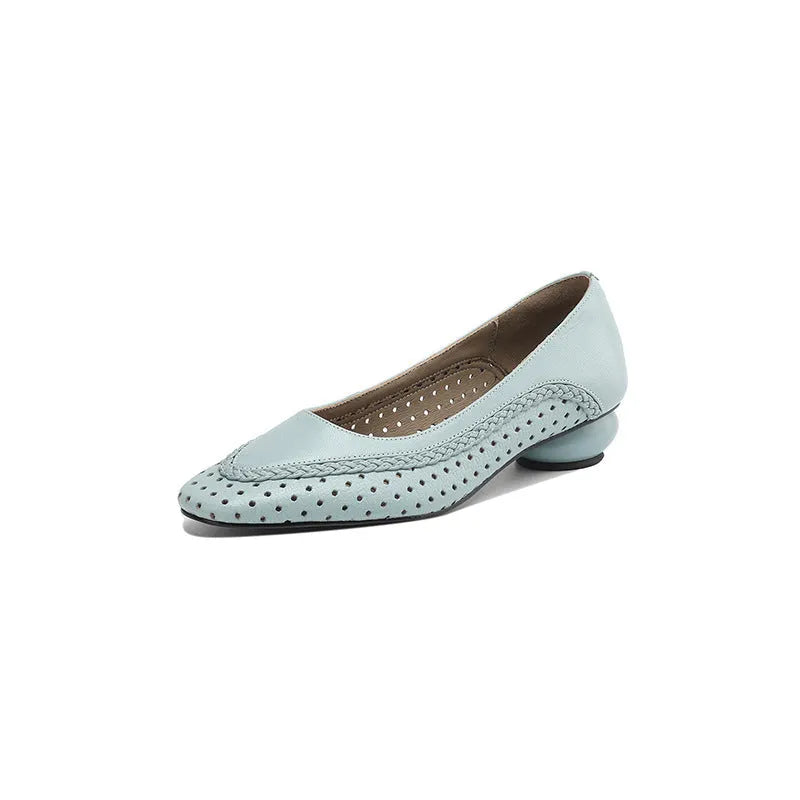 Women's beige mid-heel sandals with hollow-out design and round toe on a light background.