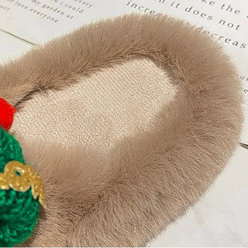 Women's Christmas hat slippers with hairy faux plush upper on a rubber sole.