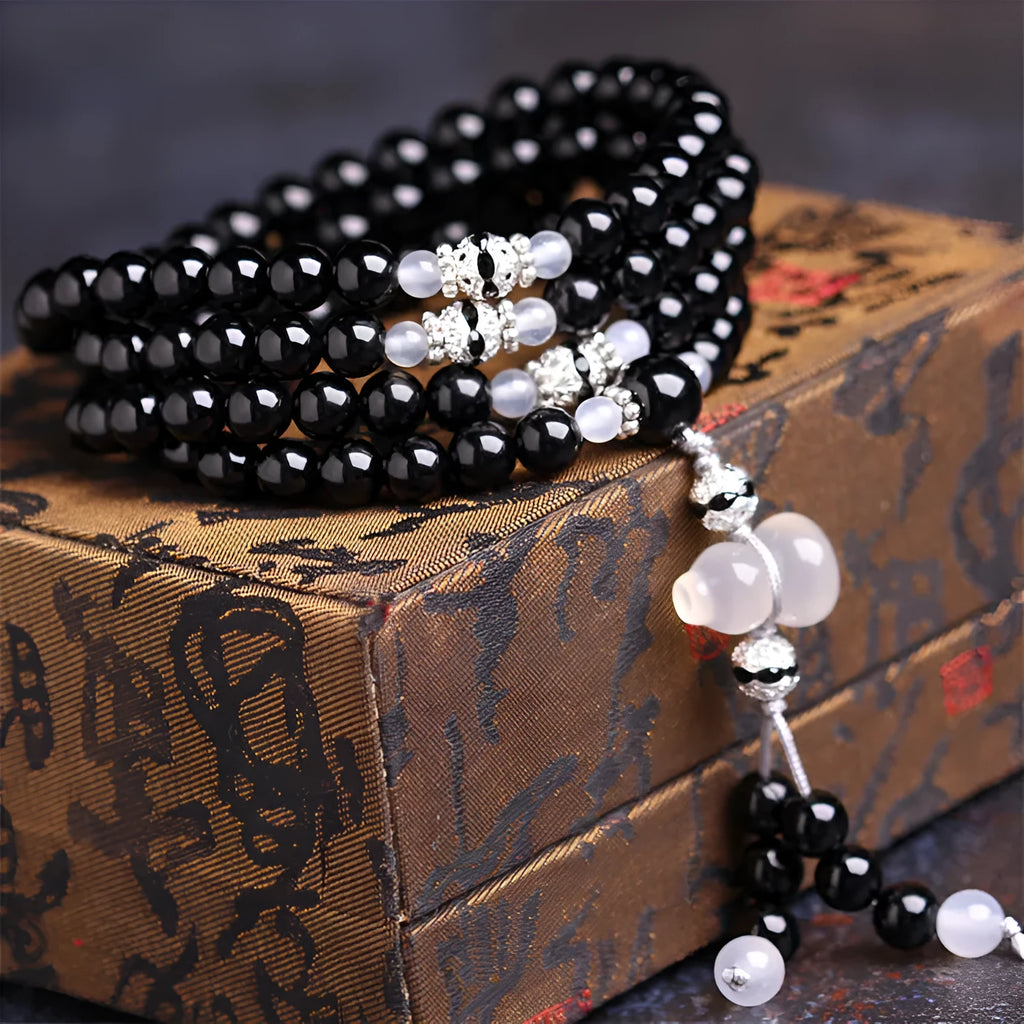 Black agate beaded bracelet with 108 geometric beads and number elements on wrist