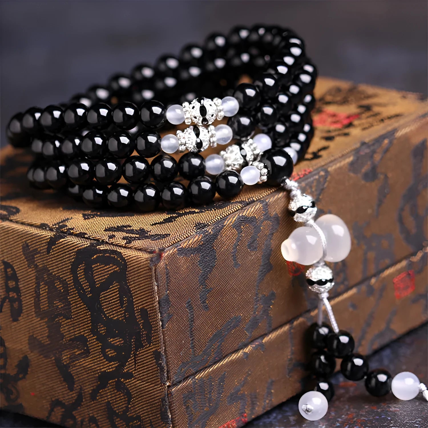 Black agate beaded bracelet with 108 geometric beads and number elements on wrist