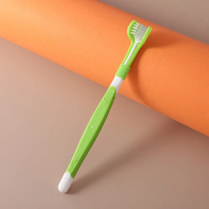 Plastic and nylon pet toothbrush in a sealed bag, colours include orange, green, and blue pink.