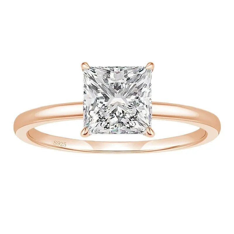 Women's geometric sterling silver ring in gold, rose gold, or silver on a grey background.