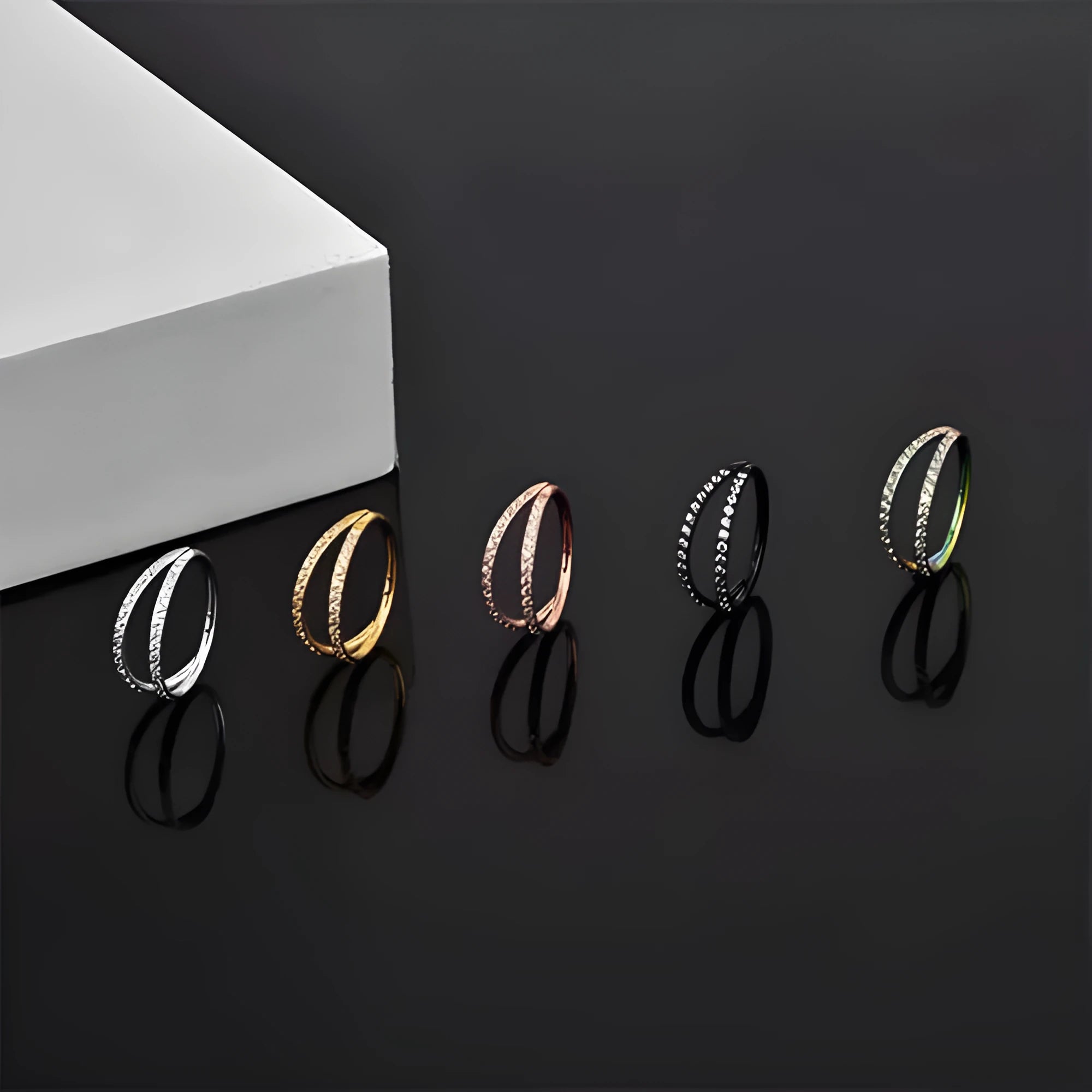 G23 titanium alloy nose ring with zircon detail in gold and steel colours, showing 1.0mm and 1.2mm diameter options.