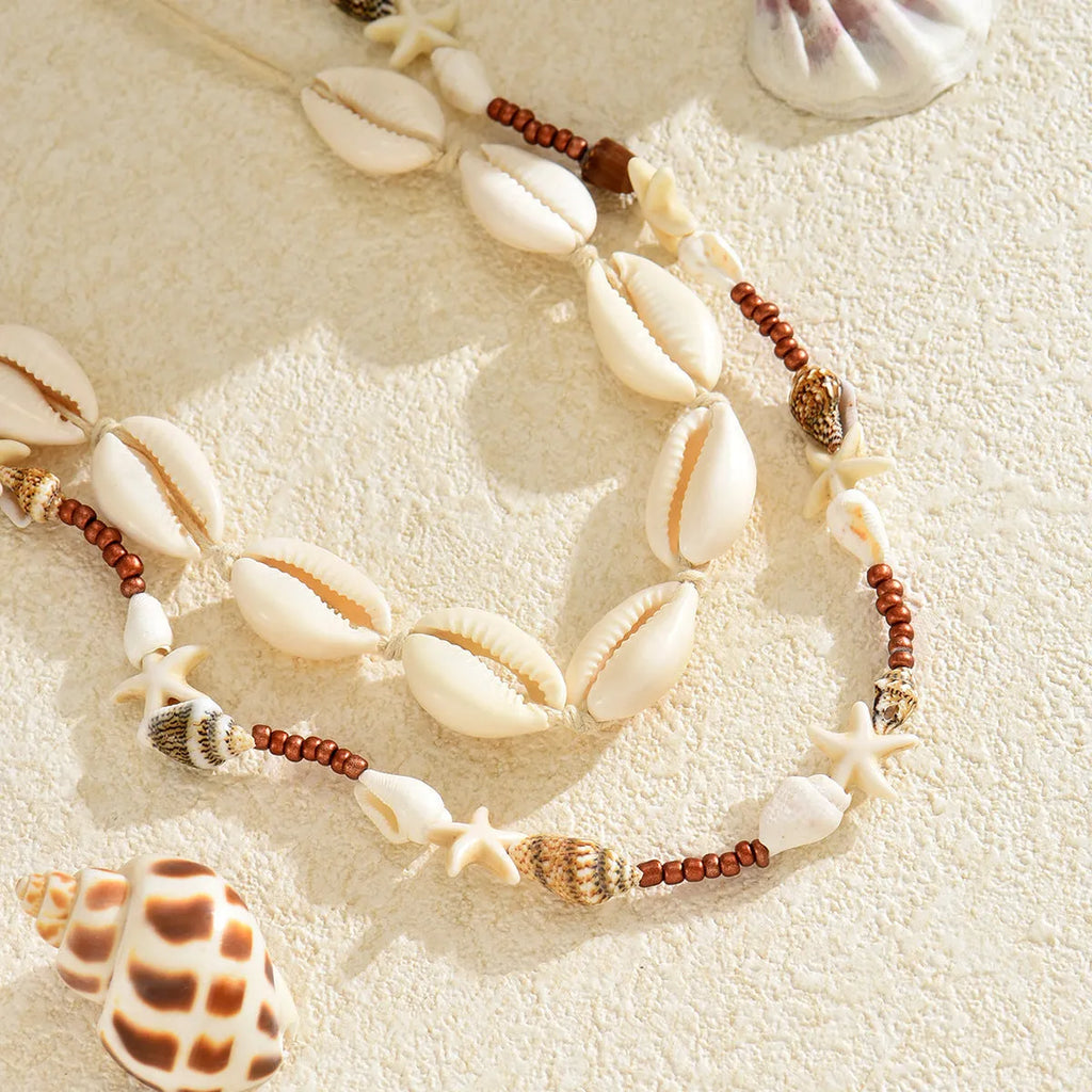 Women's bohemian shell necklace with geometric pendant on regular chain in colour X1900