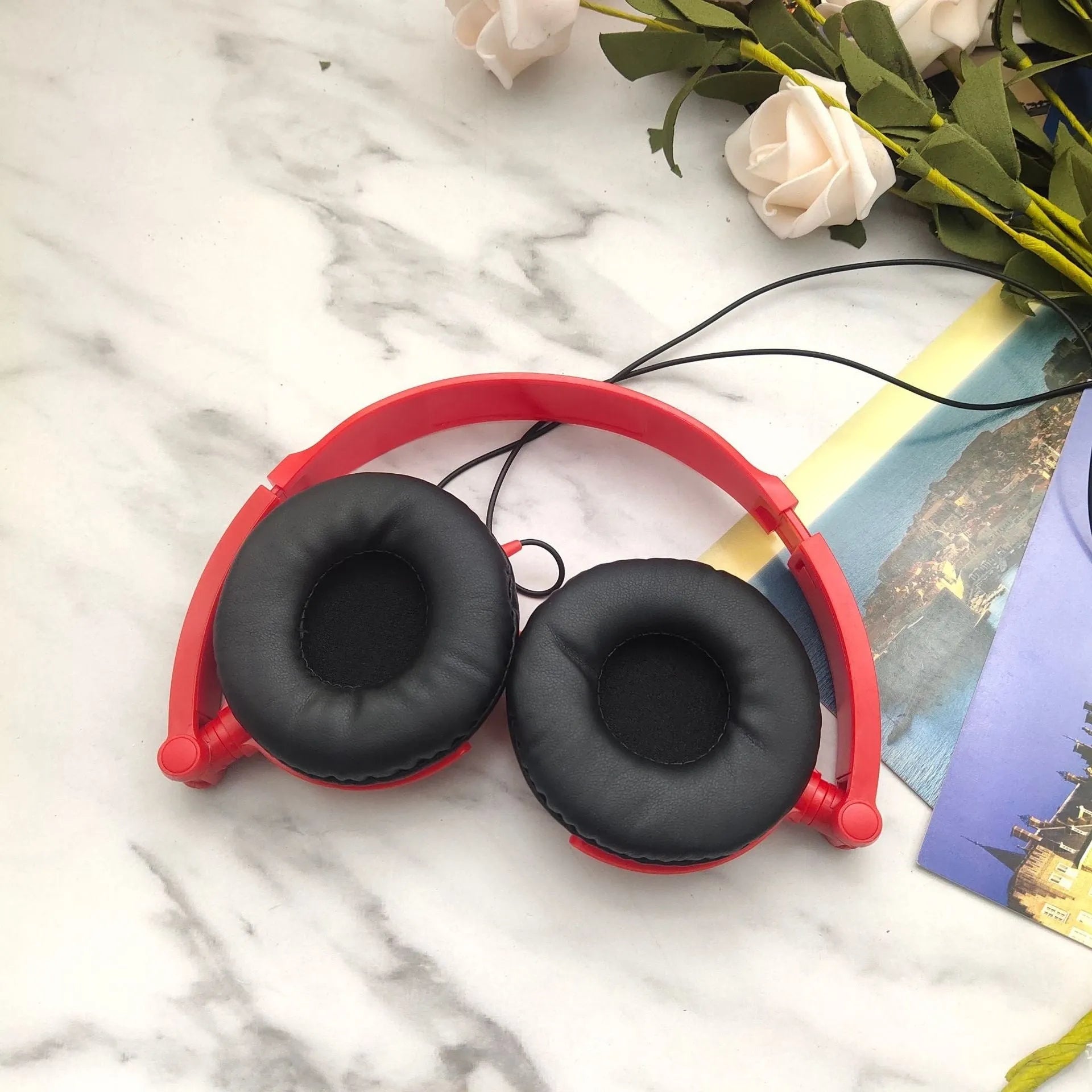 Black foldable wired over-ear headphones with an adjustable headband and a 3.5mm plug.