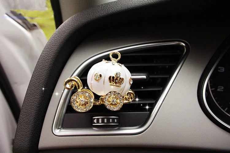 Alloy car fragrance clip with decorative charm attached to car air vent