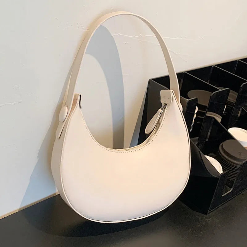 Retro dumpling-shaped women's shoulder bag in PU leather with a front pocket.