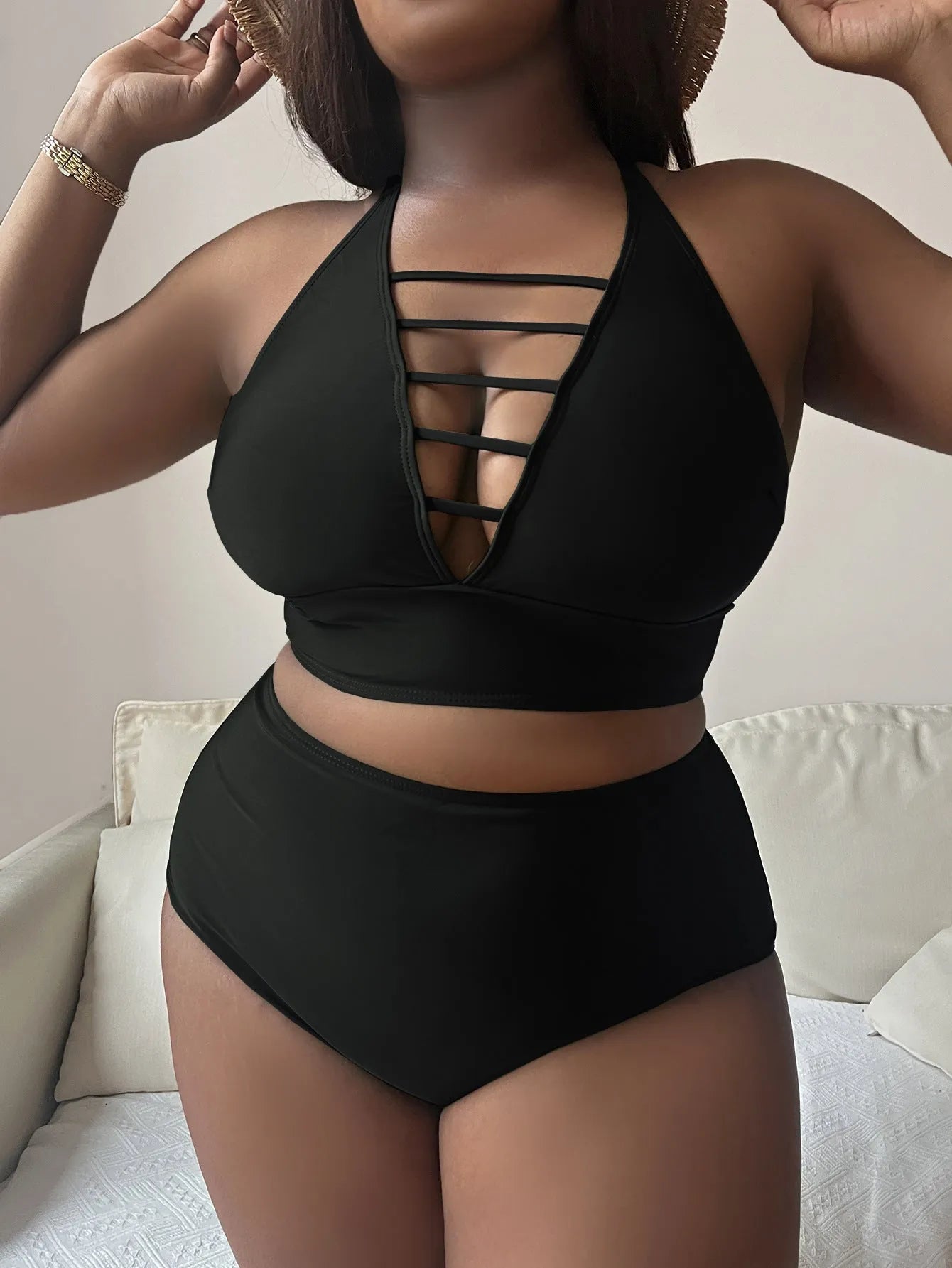 Plus size black halter bikini set with adjustable cross straps and high-waisted briefs.