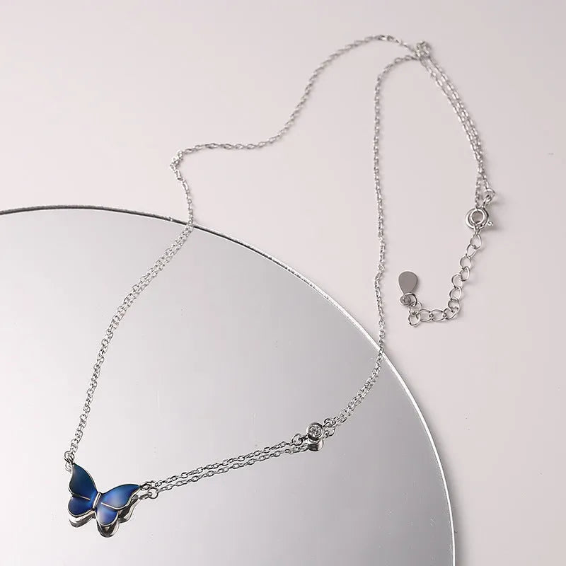 S925 silver butterfly necklace with white silver colour-change pendant on display