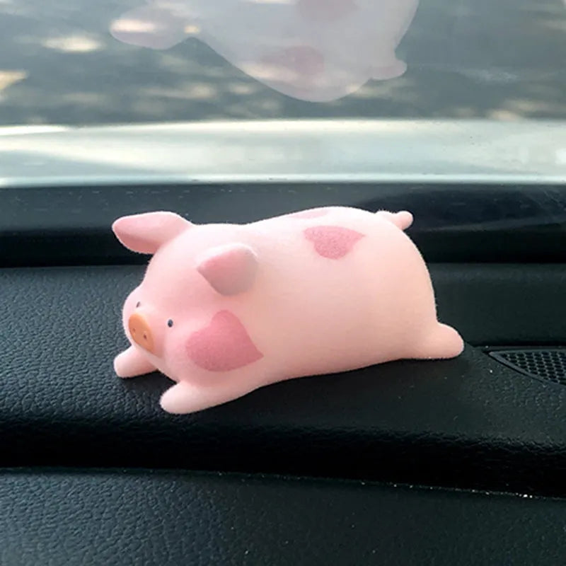 Set of eight cute cartoon pig resin car dashboard decorations on a car console