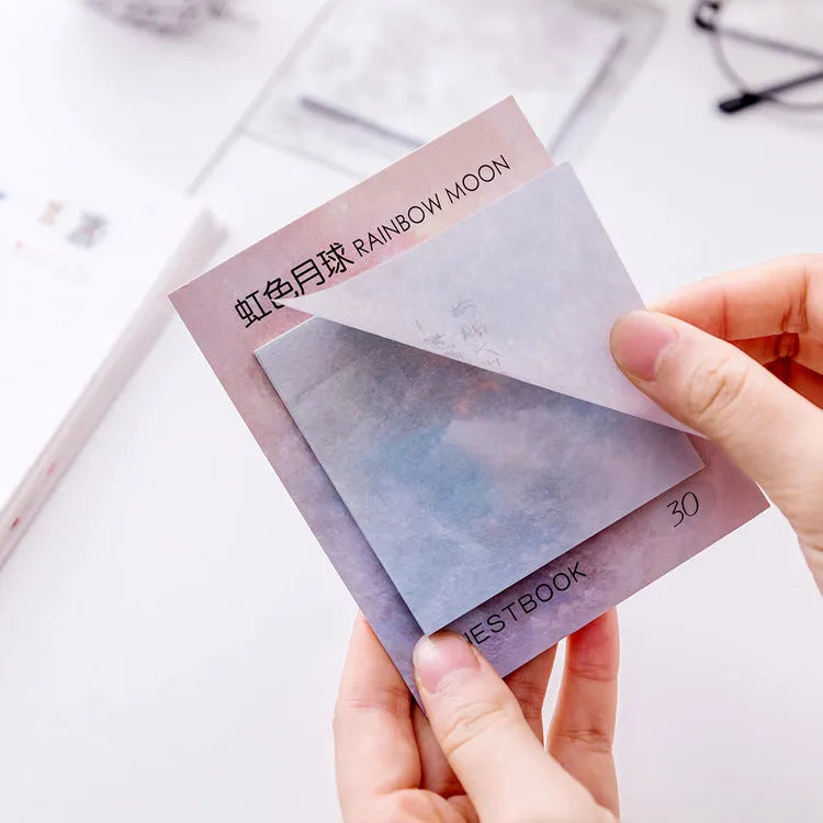 Square planet sticky notes pad showing celestial oil painting designs in six colour variations