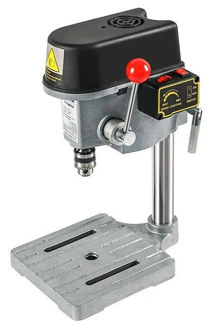Mini bench drill and milling machine on a workbench with bench pliers.