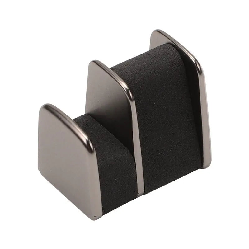Zinc alloy and leather car dashboard glasses clip holder in green, shown on a car dashboard.