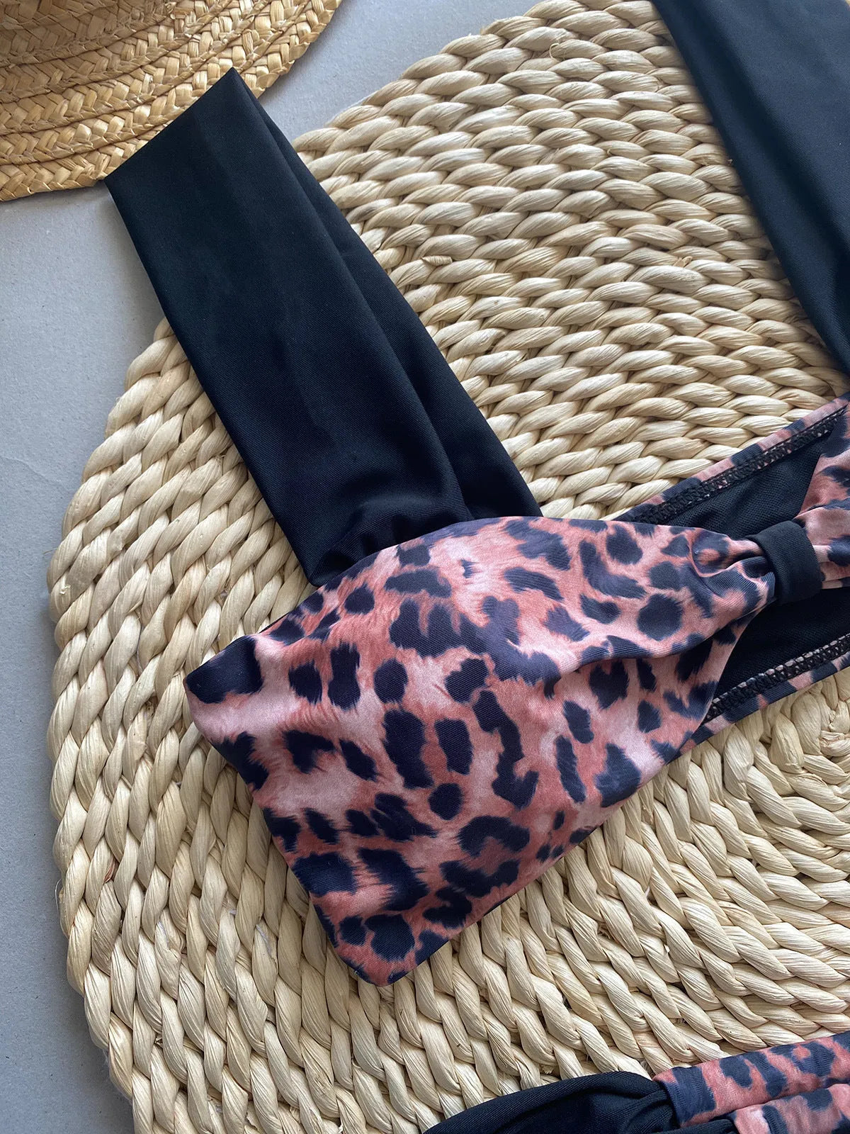 Women's leopard print bikini set with tube top and split bottoms in black and animal print
