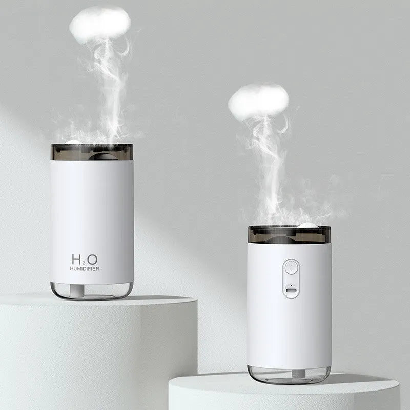 White USB jellyfish smoke ring humidifier with warm night light on a table, showing nano mist.