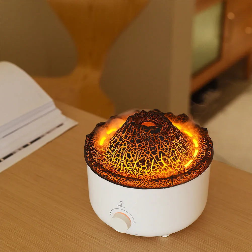 White columnar simulated flame volcano humidifier with remote control on wooden surface