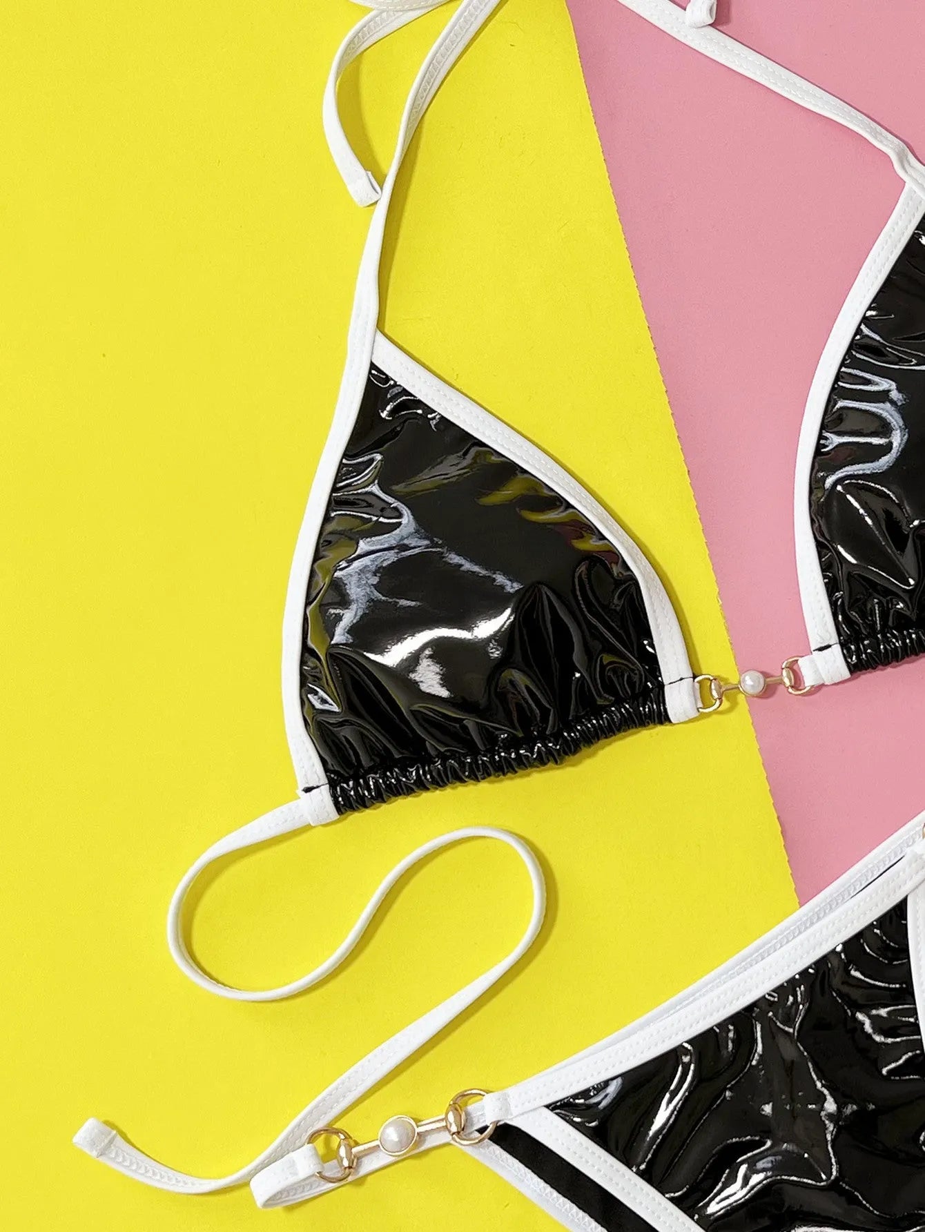 Black solid colour women's bikini swimsuit with triangle top and split briefs.