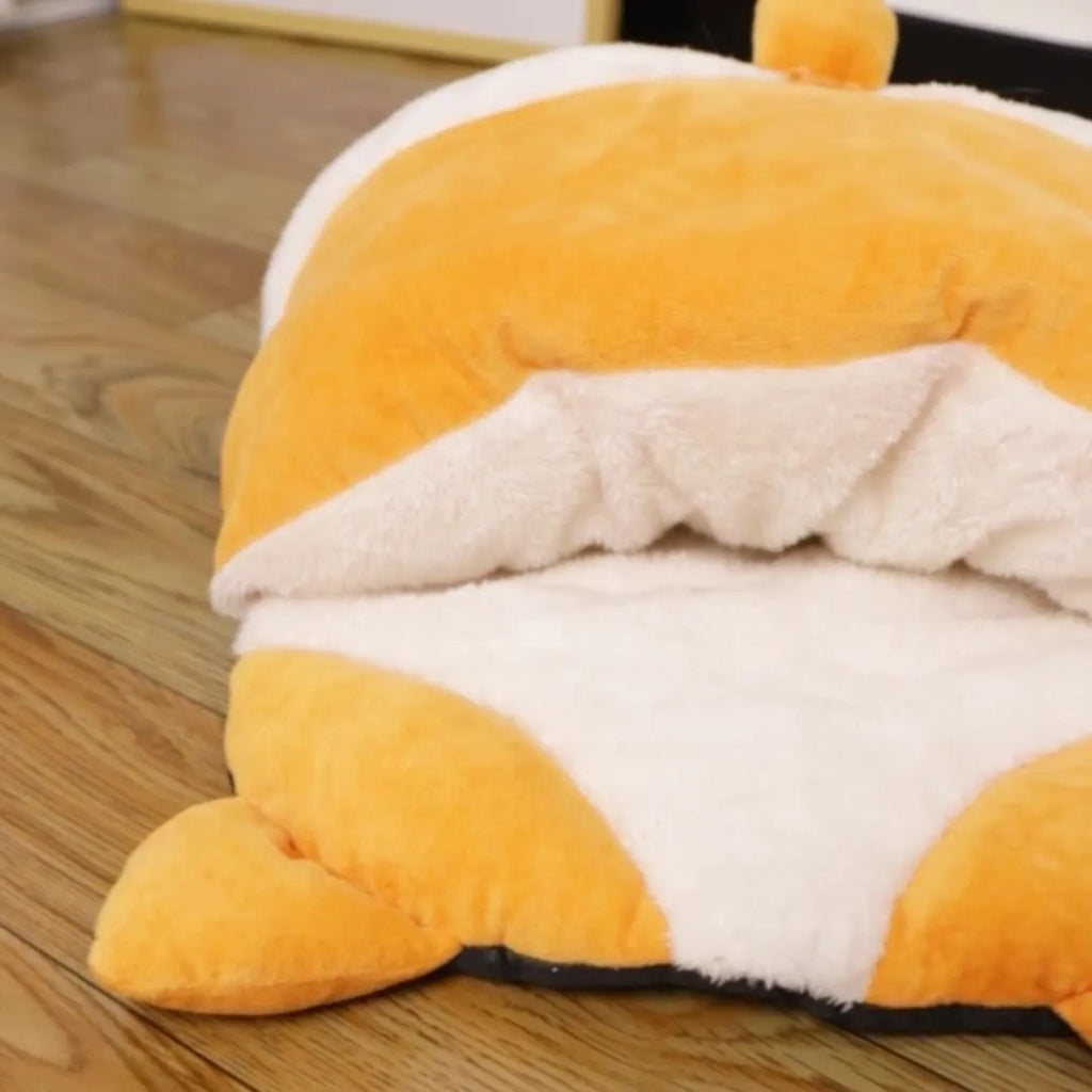 Orange semi-closed cat sleeping bag bed measuring 65cm by 53cm.