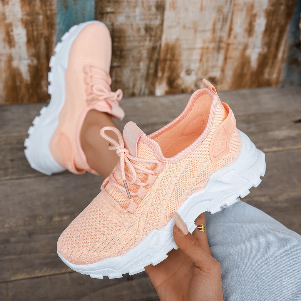 Women's white Flyknit mesh sports casual shoes with flat heel and lace-up front.