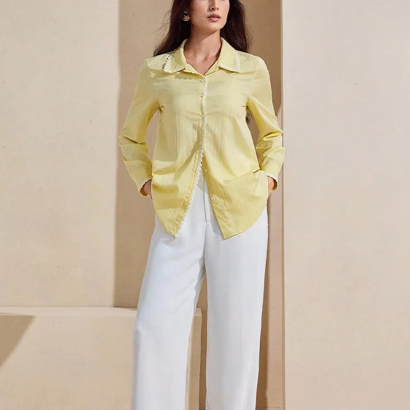 Women's solid yellow lace long-sleeved cardigan top with stitching detail on a plain background