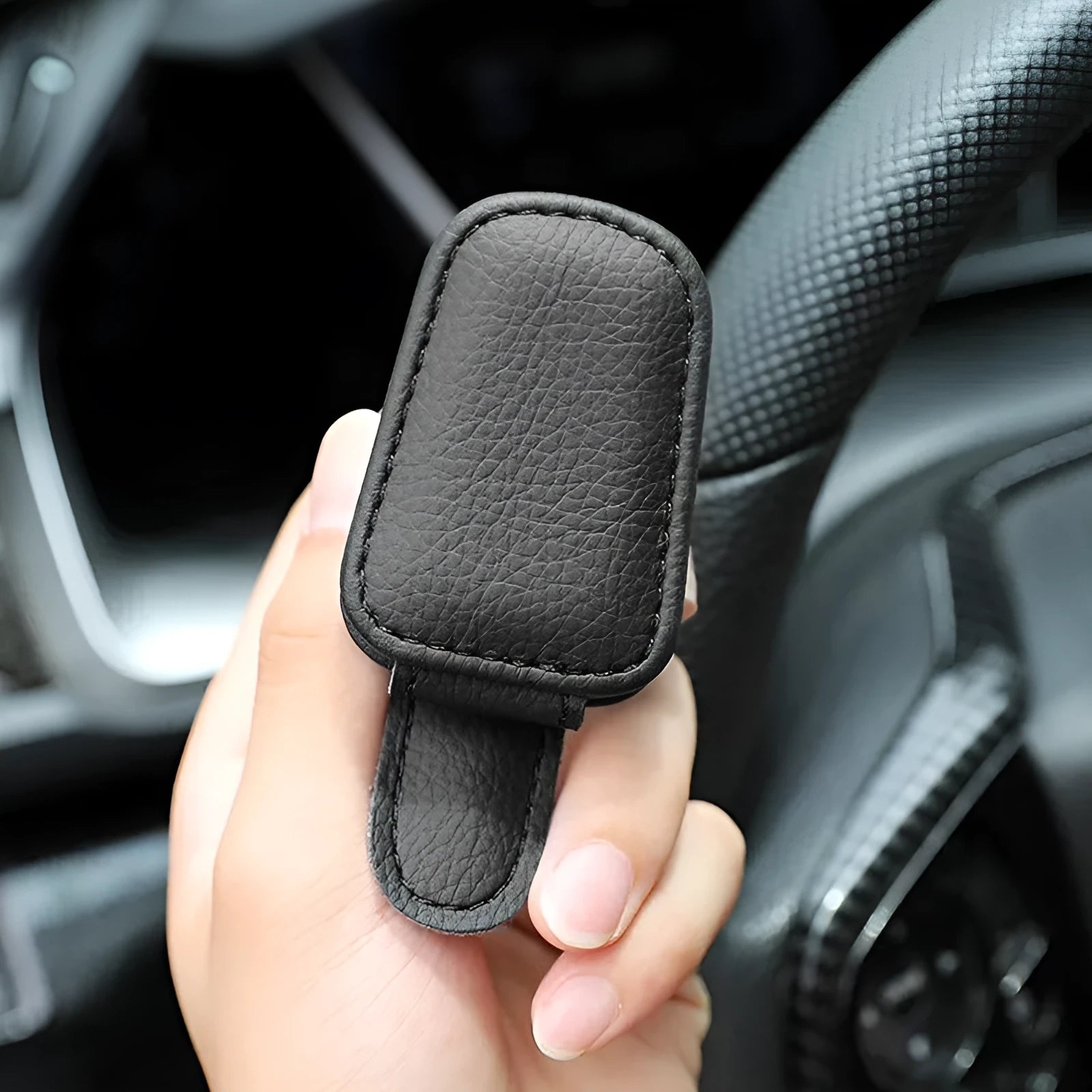 PU leather sunglasses clip holder attached to a car sun visor