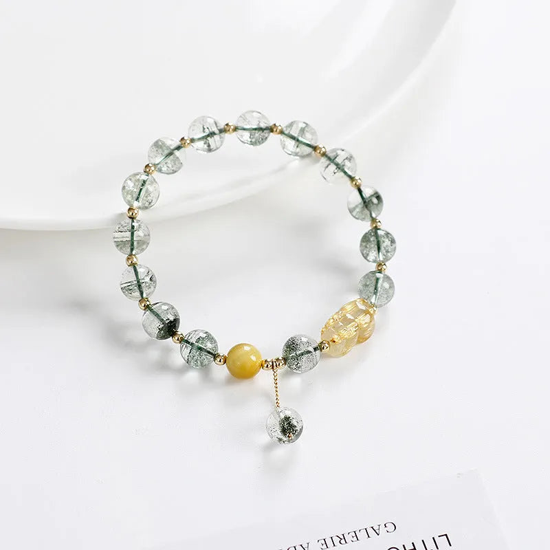 Green phantom quartz crystal bracelet with gold rutilated strands and 8mm geometric beads