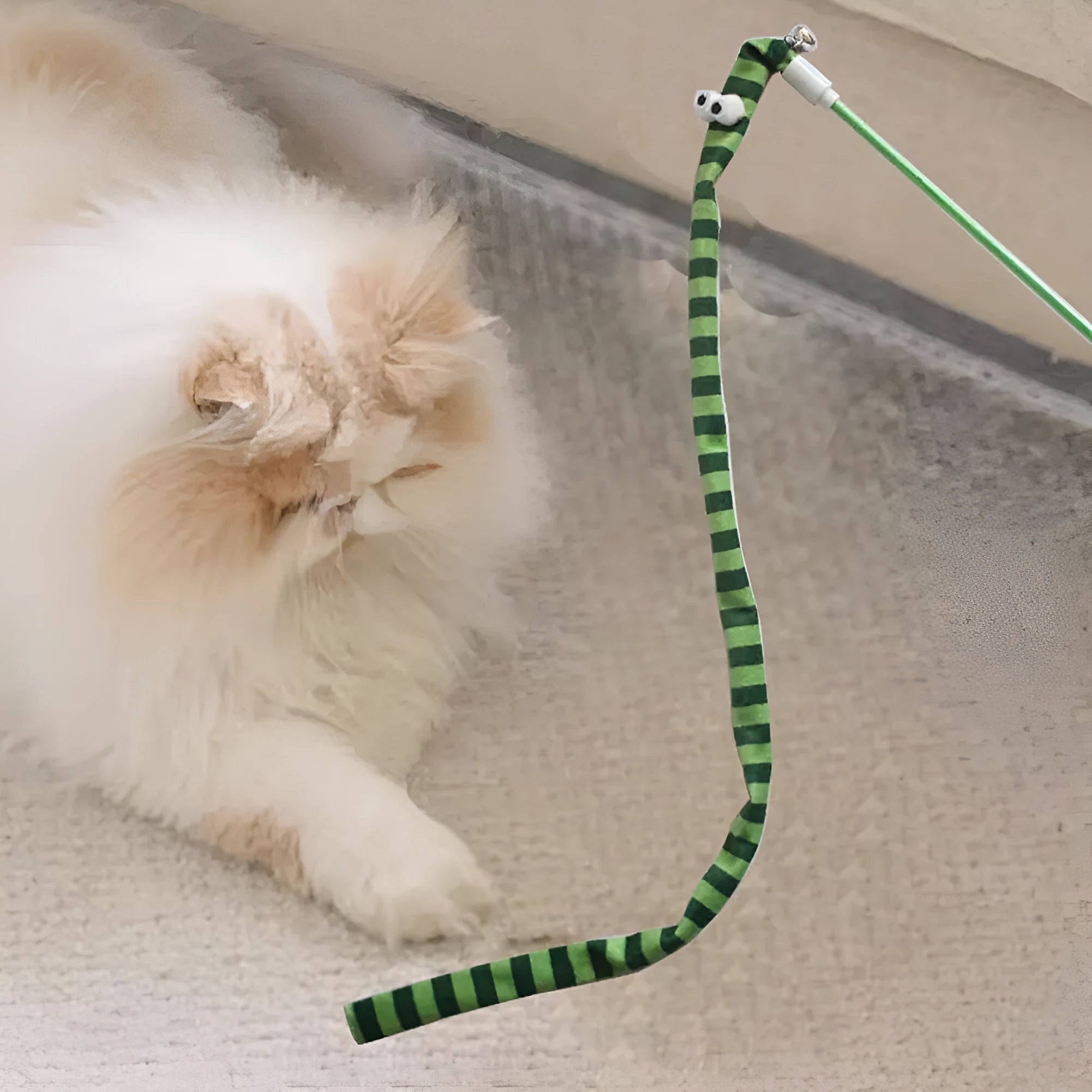 Cat wand toy with polycarbonate handle and long plush strip in vibrant colours, shown with bell attachment.