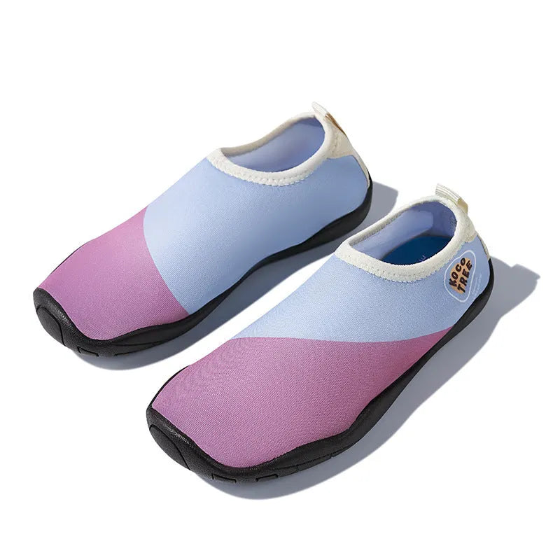 Children's anti-slip beach shoes in five colours with rubber sole and polyester upper.