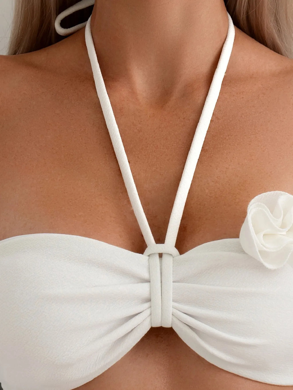 White halter neck lace-up bikini with split-cup design and three-dimensional floral details