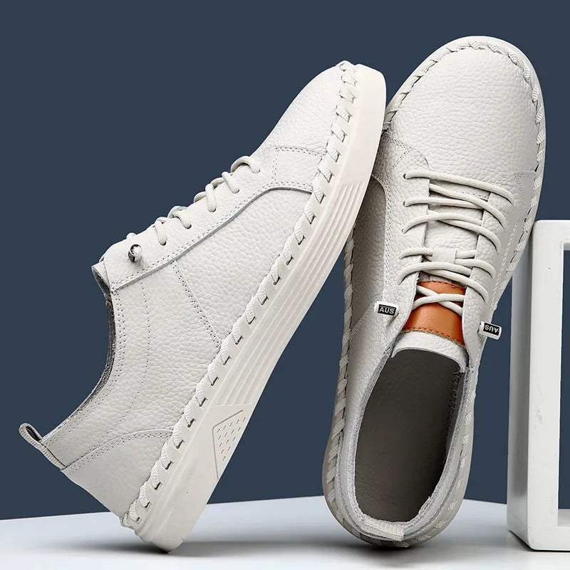 Men's beige casual leather sneakers with mesh lining and round toe stitching detail.