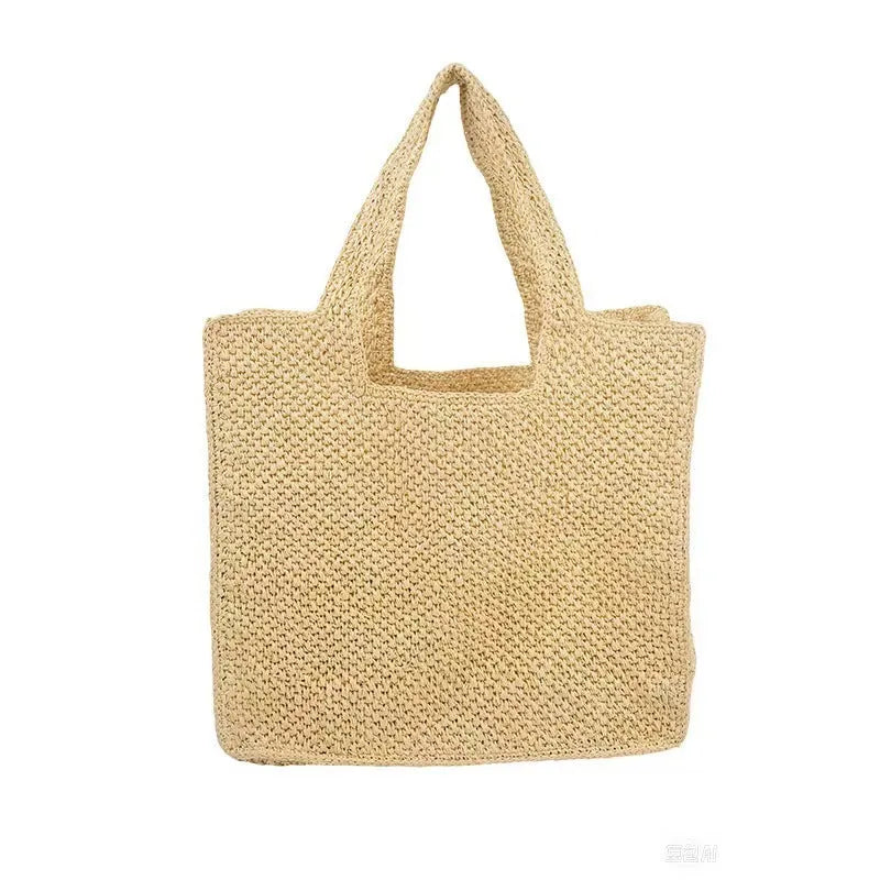 Khaki coloured woven straw tote bag with double straps showing open top and horizontal square shape.