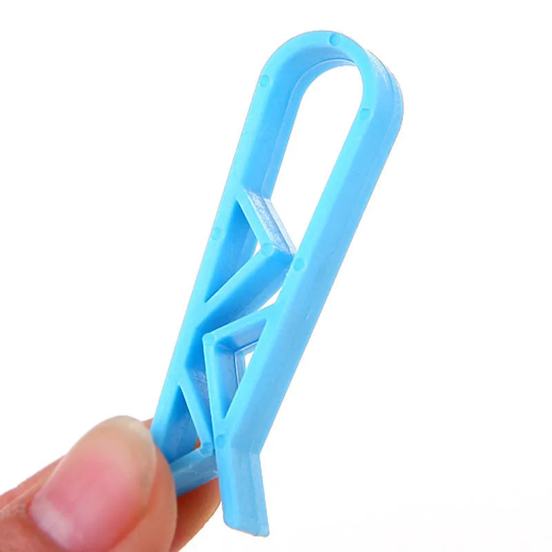 White PP plastic non-slip clip for fixing a bin liner to the side of a kitchen rubbish bin.