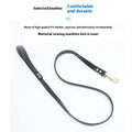Black PU leather dog traction belt with metal clip, laid out to show length.