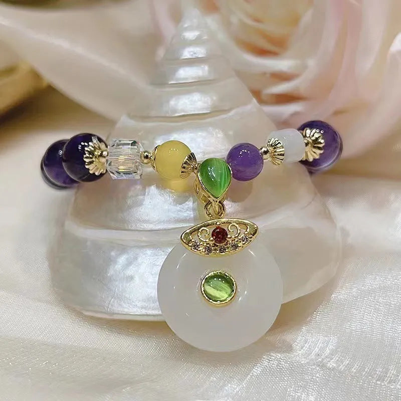 Purple amethyst bracelet with money bag pendant and peace buckle on wrist