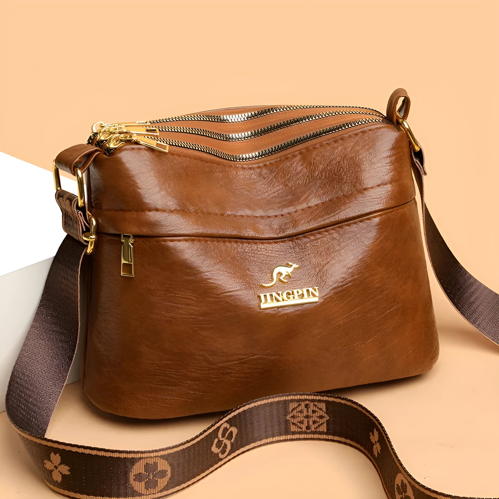 Brown cross body bag with multiple compartments and horizontal suitcase shape