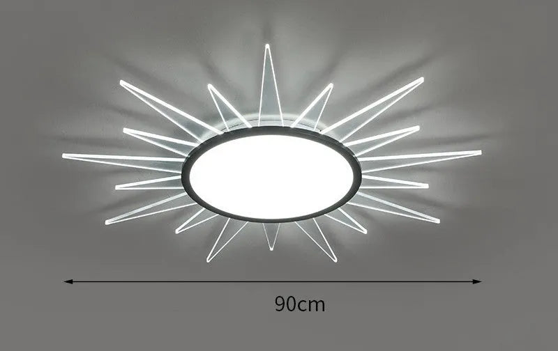 Modern round aluminium LED ceiling lamp with remote control for dimming, shown in a living room setting.
