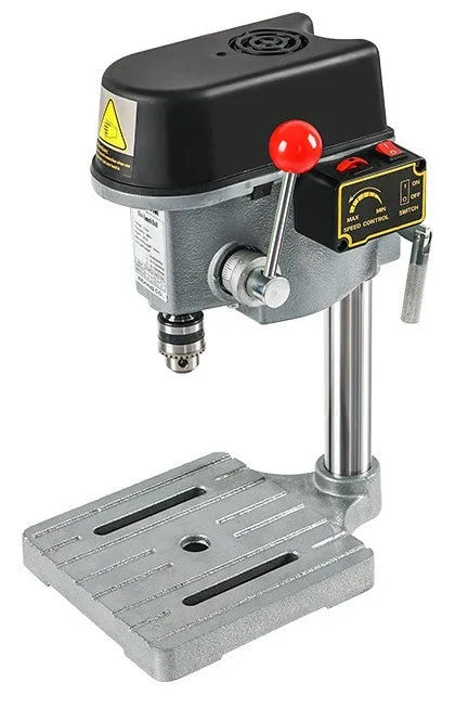 Mini bench drill and milling machine on a workbench with bench pliers.