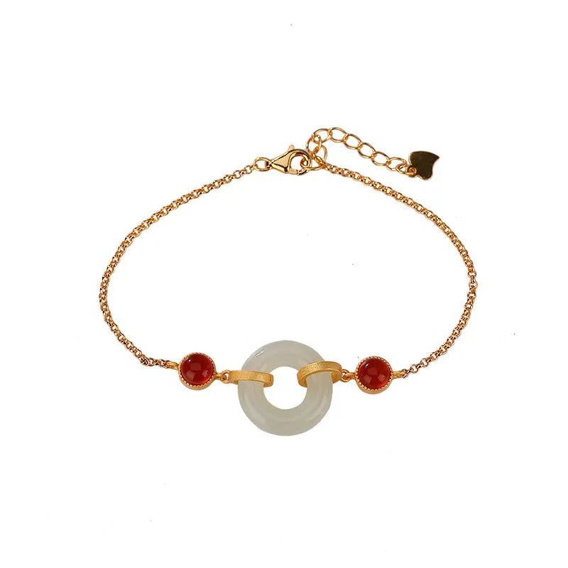 Women's sterling silver bracelet with gold-plated finish and natural Hetian jade peace buckle on adjustable chain