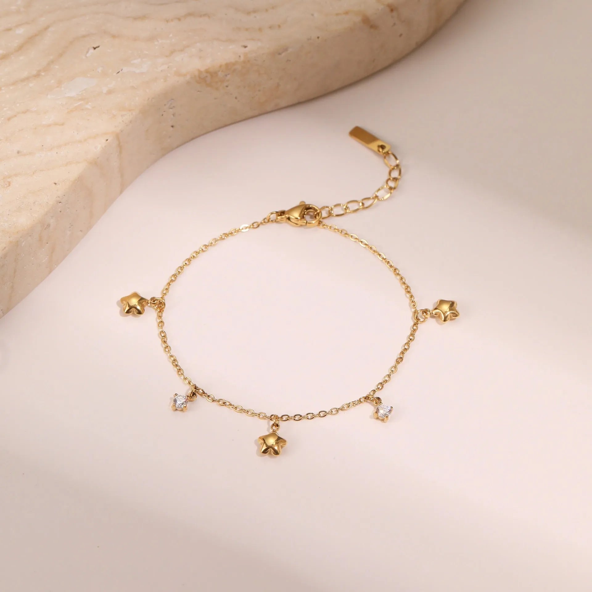 Women's stainless steel bracelet with 18K gold plating and a hexagonal zircon star pendant.