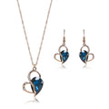 Rose gold two-piece jewellery set with heart pendant, water wave chain necklace, and earrings on display