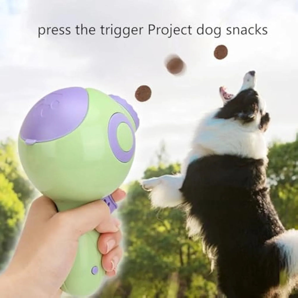 Green, orange, and pink plastic dog treat launcher toy with dispenser for interactive play and training.