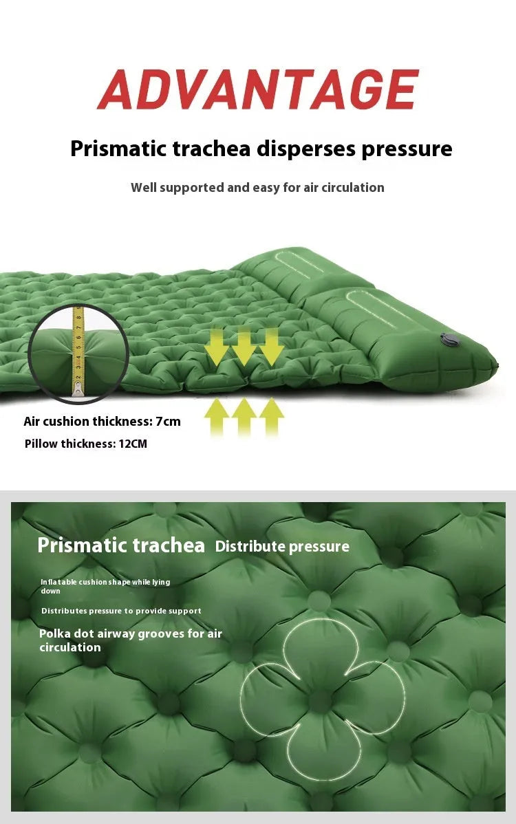 Double size inflated air mattress in army green colour with an attached pillow, on a grass surface.